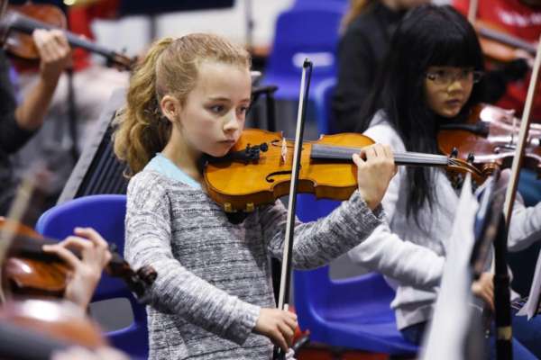 A young violinist from NYOS Junior Orchestra rehearsing at Strathallan School in July 2015
