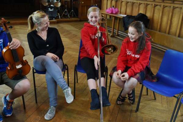 Conductor Holly Mathieson chats with musicians from NYOS Junior Orchestra