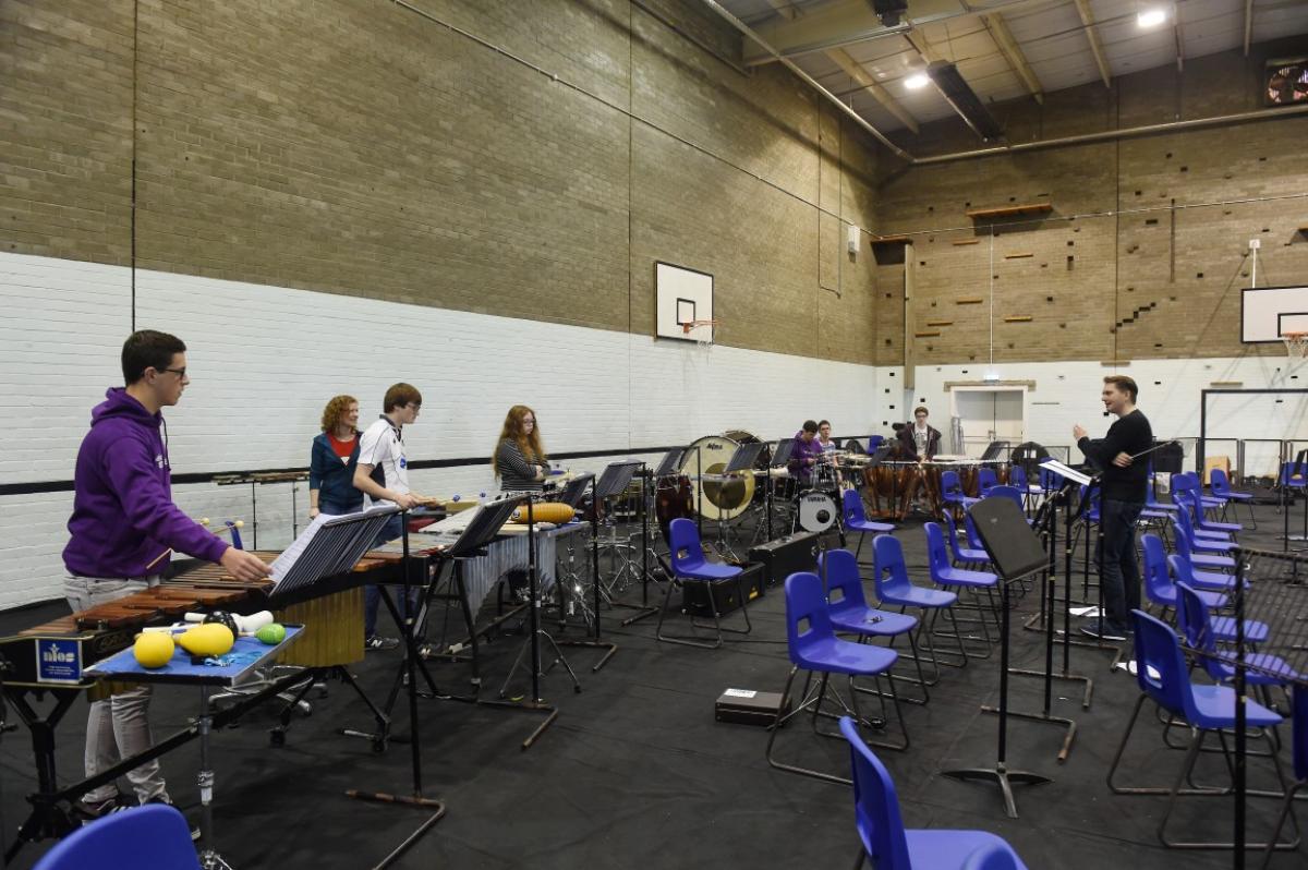 Conductor James Lowe taking the percussion section through their paces at Strathallan 2016