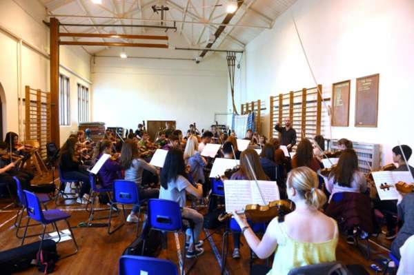 Tutor Chris George with NYOS Senior Orchestra String Section