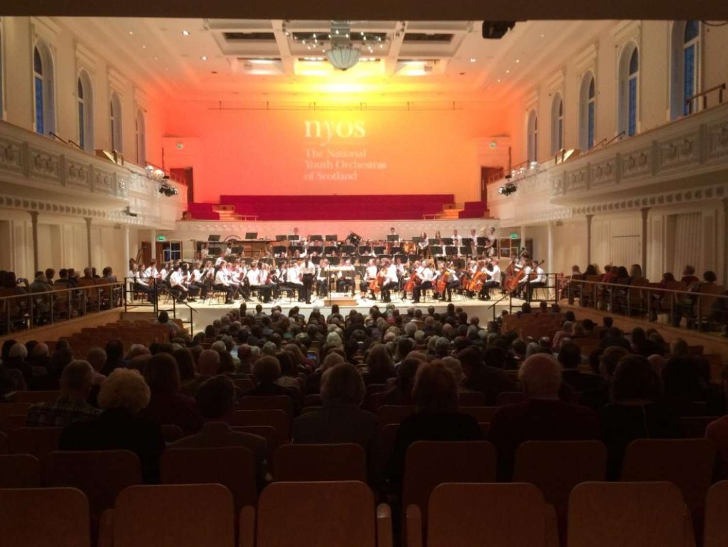 NYOS Senior Orchestra on stage, complete with new branded gobo above at Glasgow's City Halls, April 2017