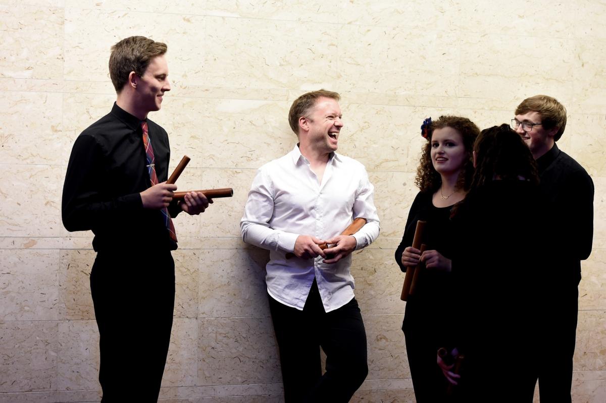 Colin Currie enjoying a laugh with NYOS Symphony Orchestra\'s percussion section before performing Steve Reich\'s Music for Pieces of Wood in the Exhibition Hall at Glasgow Royal Concert Hall 