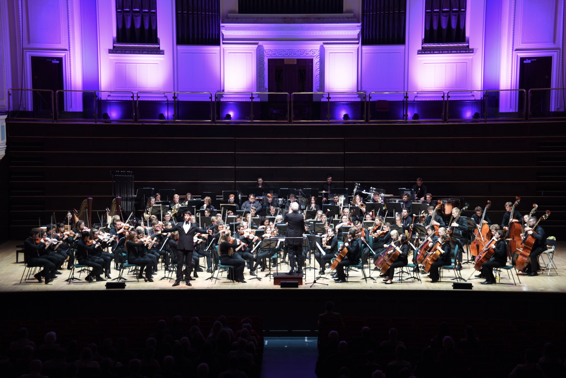 NYOS Symphony Orchestra on stage at Dundee\'s Caird Hall alongside Surrey-born baratone Mark Nathan, August 2018. 