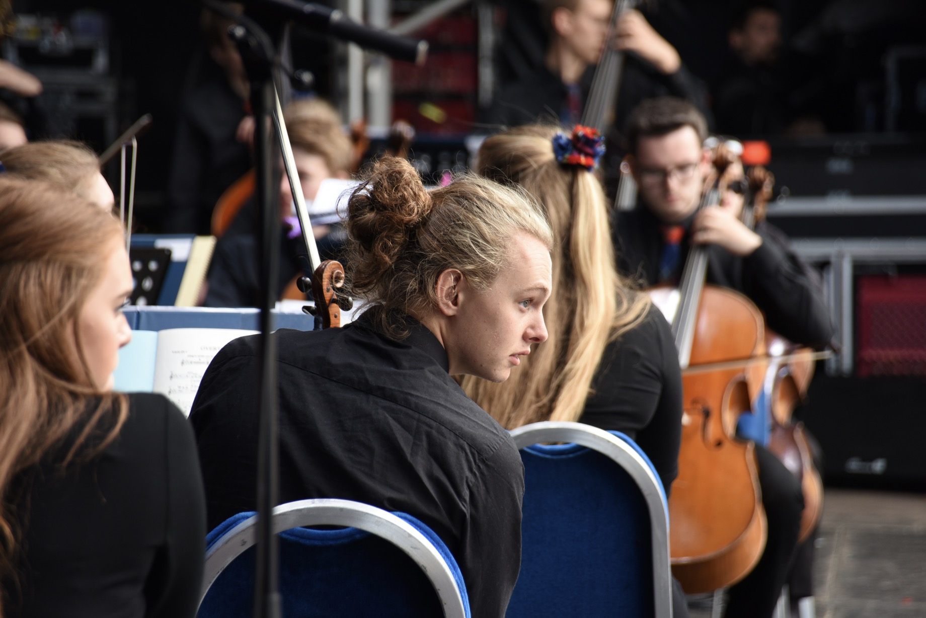 Violinist Ruaridh Geddes looks on at the audience in Glasgow\'s George Square as anticipation grows for the opening piece of a special Gala Concert. Part of the European Champioship Games Cultural Festival, August 2018.